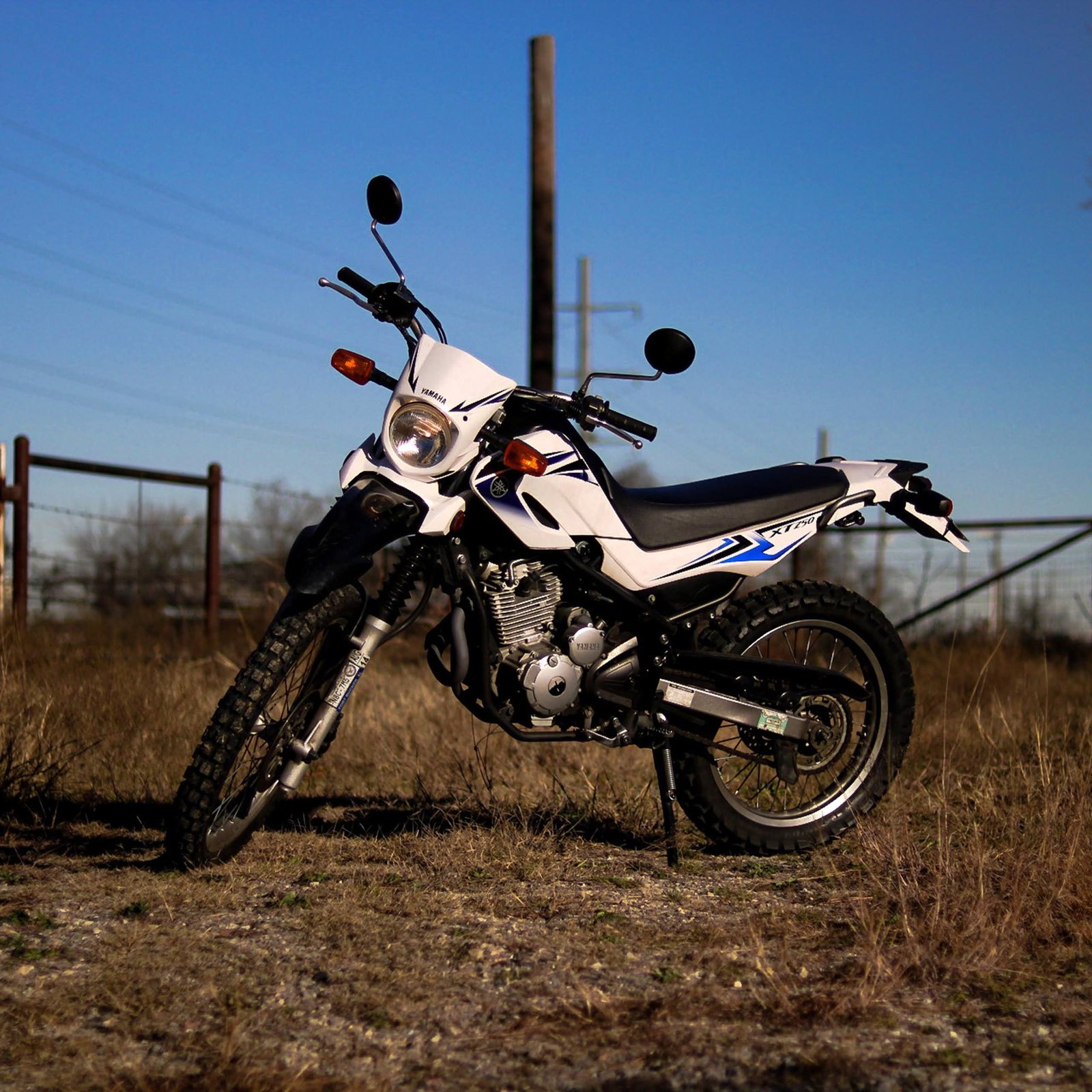 The Yamaha TW200 remains a distinctive dual-sport motorcycle built around simplicity, manageable performance, and a wide-tire.